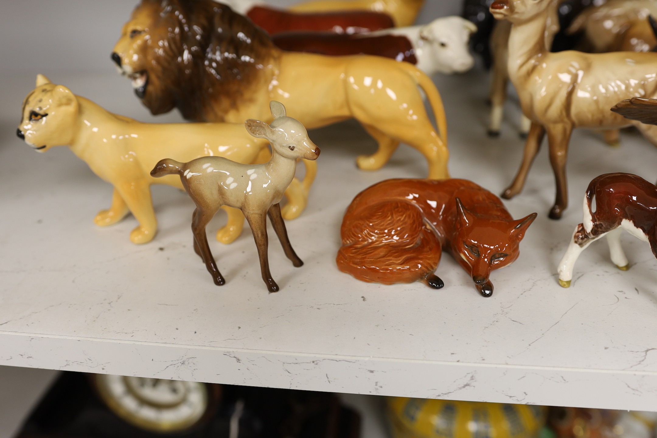 A selection of Beswick animals, to include four bulls and two calves, stag, deer, fawn, fox, panda, falcon, donkey, foal, lioness, lion, and a lion cub (17)